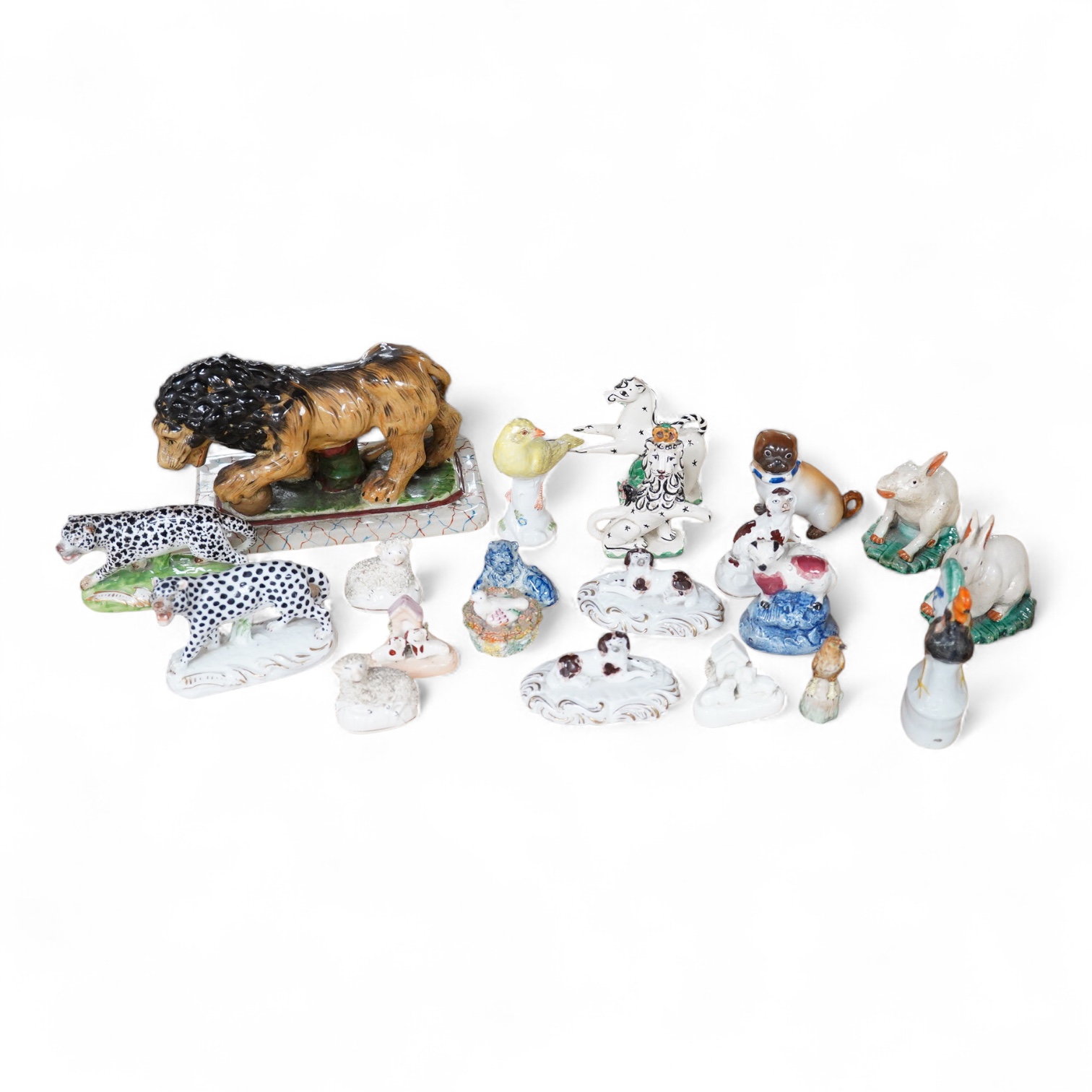 A collection of 19th/20th century Staffordshire and continental porcelain models of animals and birds, including a 20th century Meissen figure of a canary, two Continental porcelain Panthers, two similar recumbent dogs,